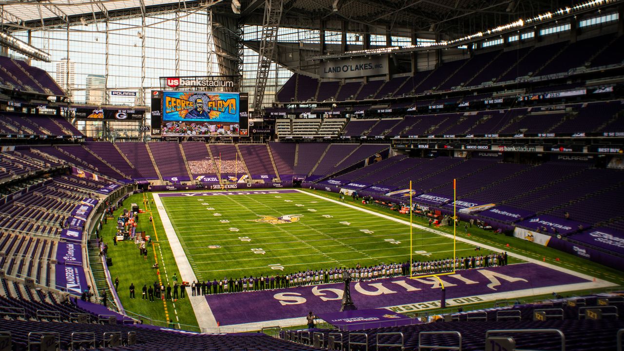 The Minnesota Vikings stand with arms linked as the team pays tribute to George Floyd before the game against the Green Bay Packers at U.S. Bank Stadium on Sunday, September 13.