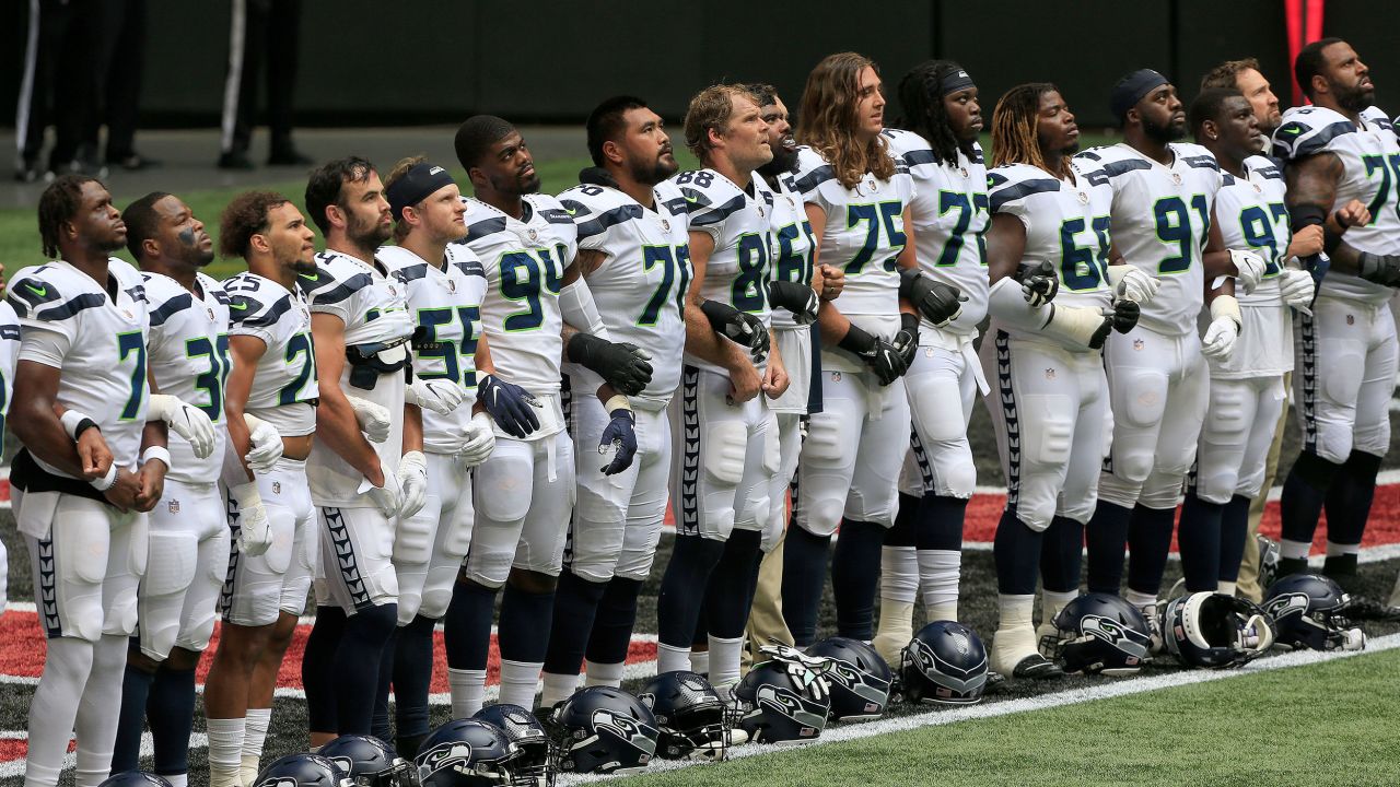 The Seattle Seahawks line up in the end zone as "Lift Every Voice and Sing" is played before their game against the Atlanta Falcons at Mercedes-Benz Stadium in Atlanta, Georgia, on Sunday.