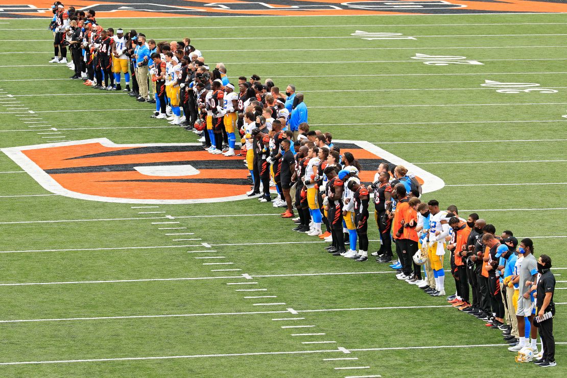 The Cincinnati Bengals and the Los Angeles Chargers stand in unity during the National Anthem at Paul Brown Stadium in Cincinnati, Ohio, on Sunday, September 13.