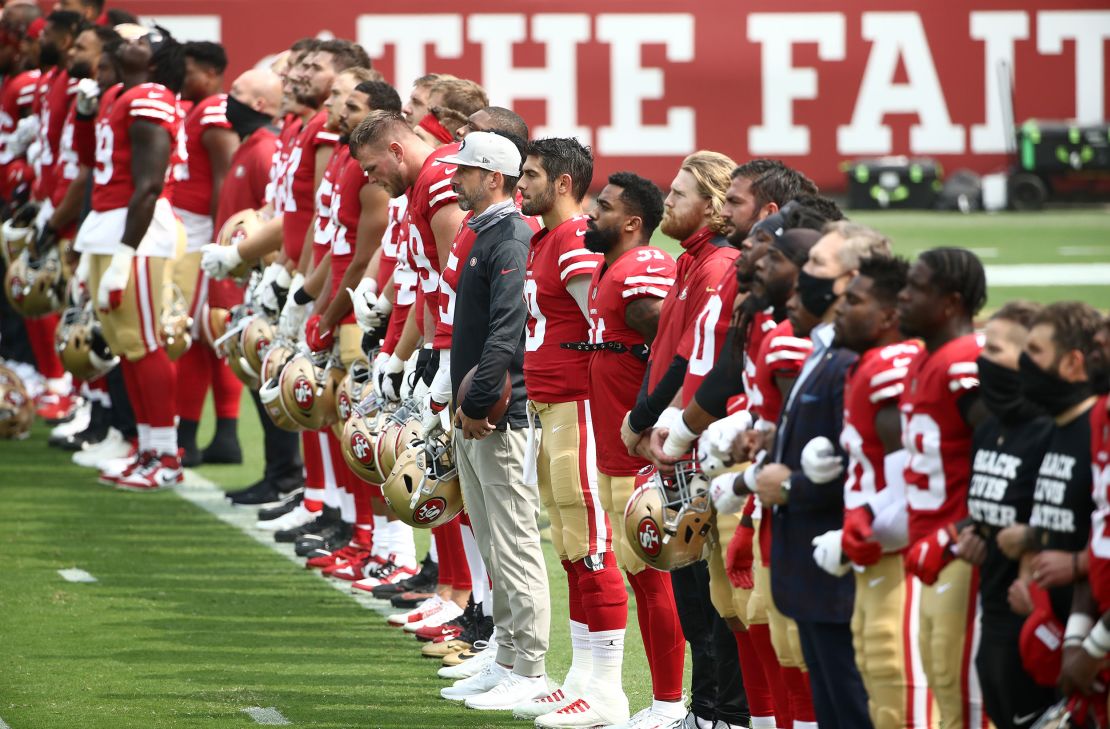 The San Francisco 49ers stand together during a presentation on social justice before their game against the Arizona Cardinals at Levi's Stadium on Sunday, September 13.
