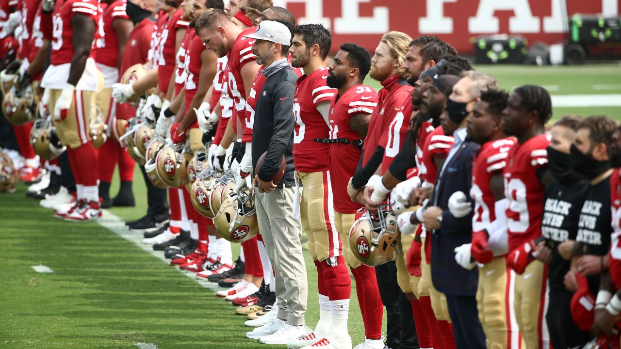 The San Francisco 49ers stand together during a presentation on social justice before their game against the Arizona Cardinals at Levi's Stadium on Sunday, September 13.