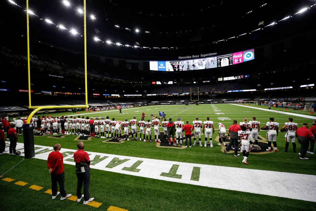 The Tampa Bay Buccaneers lock arms in a show of unity while listening to "Lift Every Voice" before their game against the New Orleans Saints at Mercedes-Benz Superdome on Sunday,  September 13.