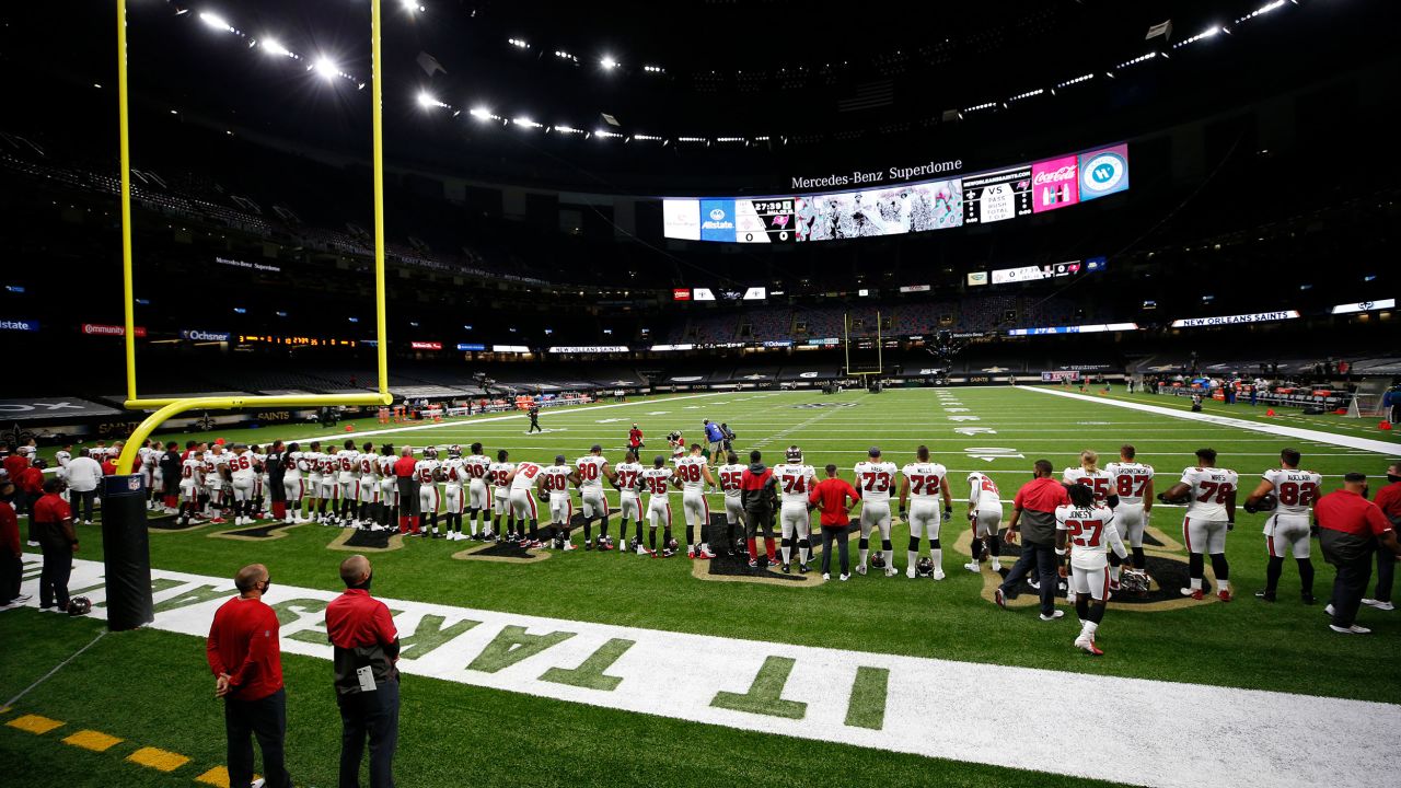 The Tampa Bay Buccaneers lock arms in a show of unity while listening to "Lift Every Voice" before their game against the New Orleans Saints at Mercedes-Benz Superdome on Sunday, September 13.