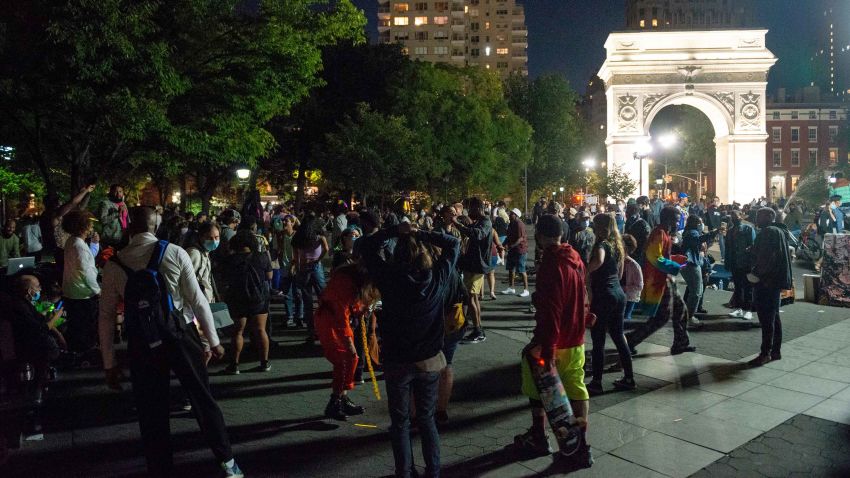 NEW YORK, NEW YORK - SEPTEMBER 12: People with and without masks gather in Washington Square Park at night as the city continues Phase 4 of re-opening following restrictions imposed to slow the spread of coronavirus on September 12, 2020 in New York City. The fourth phase allows outdoor arts and entertainment, sporting events without fans and media production. (Photo by Alexi Rosenfeld/Getty Images)