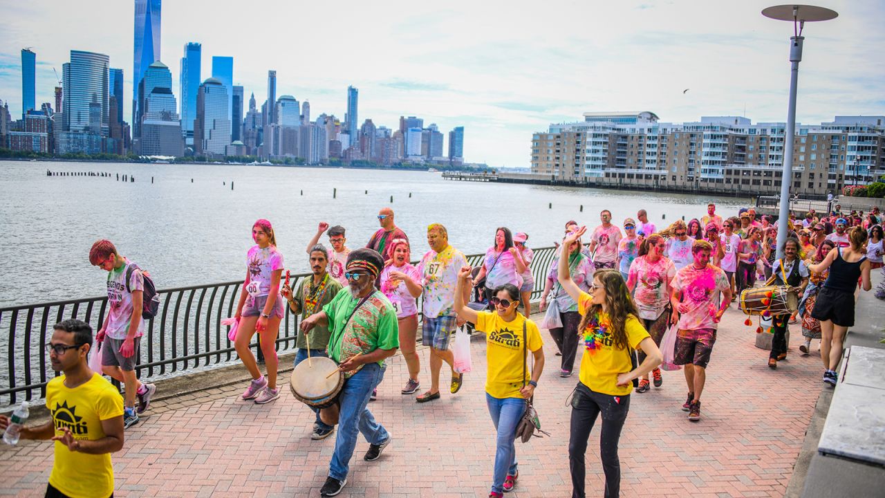 The country's most vibrant Indian neighborhood lies hidden under the silhouette of the Lower Manhattan skyline. Pictured here is the 2019 Surati Holi Hai Color Walk.