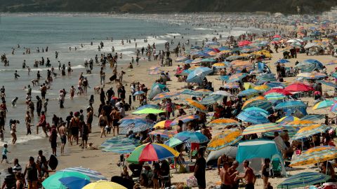 Beachgoers create a forest of umbrellas as thousands seek refuge in Santa Monica with temperatures reaching triple digits and beyond in August. 