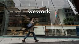 A pedestrian wearing a face mask walks past a WeWork co-working space on May 18, 2020 in Tokyo, Japan. SoftBank Group Corp. posted a record net loss of 961.6 billion yen for the fiscal year ended March 31, 2020. (Photo by Tomohiro Ohsumi/Getty Images)