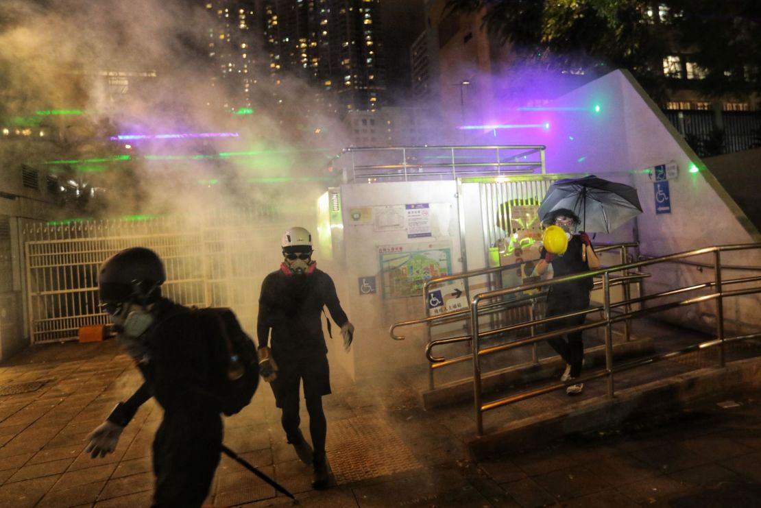 Police fire tear gas to disperse protesters gathered outside a police station in the Tsim Sha Tsui district after taking part in a rally against a controversial extradition bill in Hong Kong on August 10, 2019.
