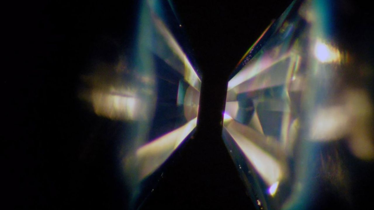 In a diamond-anvil cell, two gem quality single crystal diamonds are shaped into anvils. Samples are loaded between the culets and compressed between the anvils. 