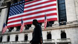 People walk by the New York Stock Exchange (NYSE) near One World Trade Center, the Freedom Tower, in lower Manhattan during commemoration ceremonies for the September 11, 2001 terror attacks on September 11, 2020 in New York City. Hundreds of people have gathered for the 19th anniversary of the event at Ground Zero to remember the nearly 3,000 who were killed on that day. But this year, due to COVID-19 pandemic restrictions, only family members are allowed to gather at the 9/11 Memorial plaza. There will also not be an in-person reading of the victims' names at the memorial and instead there will be a pre-recording of names by family members broadcast throughout the plaza and live-streamed online.  (Photo by Spencer Platt/Getty Images)