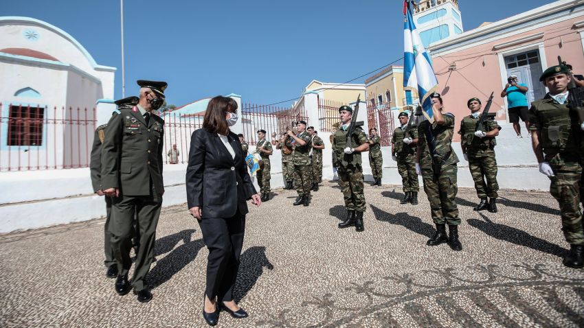 In this photo provided by the Greek President's office on Sunday, Sept. 13, 2020, Greece's President Katerina Sakellaropoulou inspects a guard of honour during celebrations marking when the southeastern island of Kastellorizo, formally became part of Greece. Greece's prime minister outlined plans Saturday to upgrade the country's defense capabilities, including purchasing new fighter planes, frigates, helicopters and weapons systems amid heightened tensions with Turkey over rights to resources in the eastern Mediterranean. (Thodoris Manolopoulos/Greek President's Office/AP)