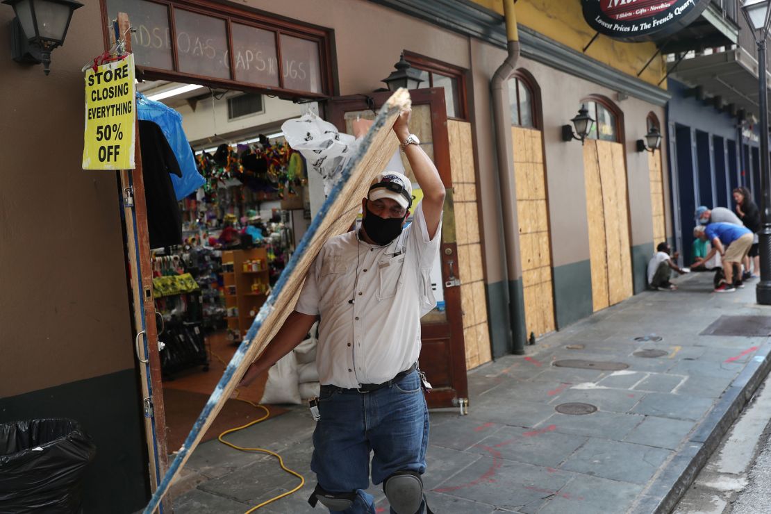 Luis A. Sanabria puts plywood over windows of a business in the French Quarter in New Orleans.