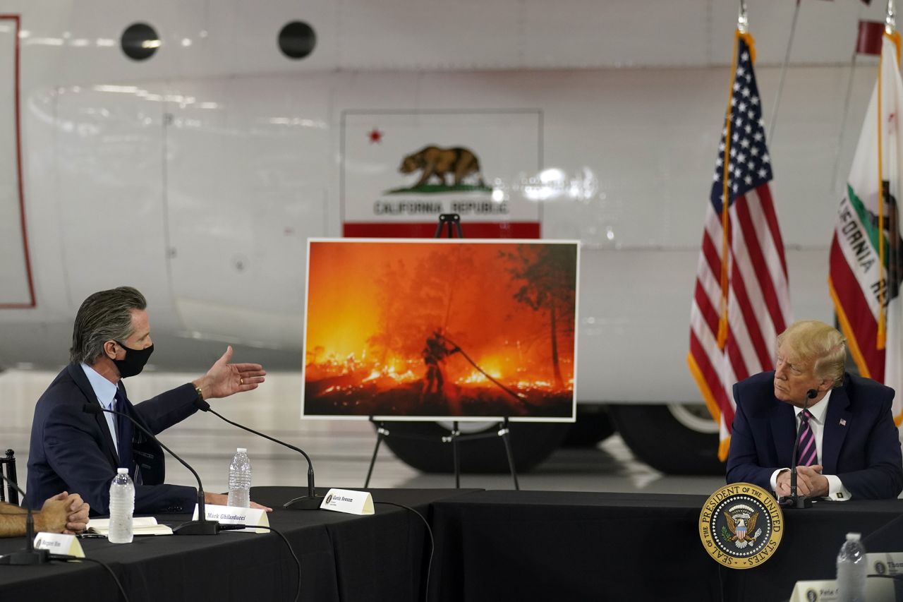 President Donald Trump listens as California Gov. Gavin Newsom speaks about the wildfires during a briefing on September 14.