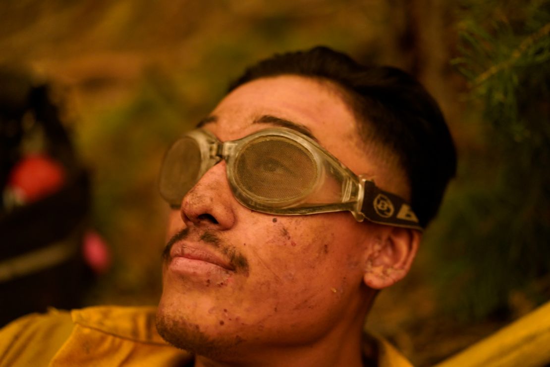 Jacob Andrade of the Kern Valley Hotshots rests after a night battling the Creek Fire.