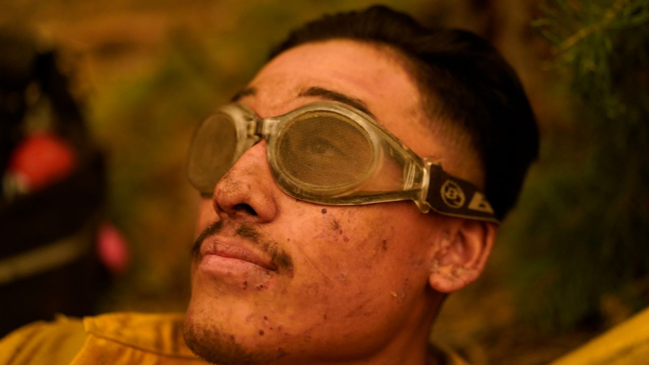 Jacob Andrade of the Kern Valley Hotshots rests after a night battling the Creek Fire.