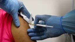 A health worker injects a woman during clinical trials for a Covid-19 vaccine at Research Centers of America in Hollywood, Florida, U.S., on Wednesday, Sept. 9, 2020. Drugmakers racing to produce Covid-19 vaccines pledged to avoid shortcuts on science as they face pressure to rush a shot to market. Photographer: Eva Marie Uzcategui/Bloomberg via Getty Images