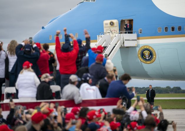 People cheer for Trump as he arrives for a rally at MBS International Airport in Freeland, Michigan, on September 10.