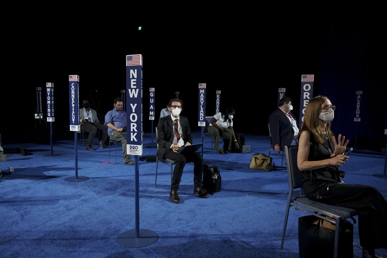 Members of the media are spread out from one another before Harris' speech during the Democratic National Convention.