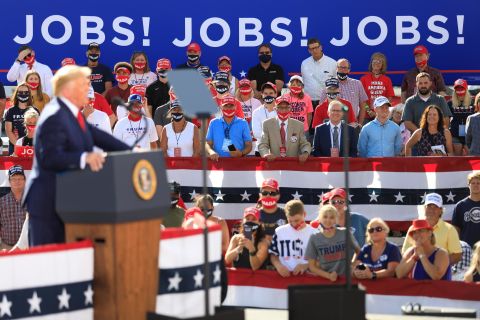 Supporters look on as Trump delivers remarks at a rally in Oshkosh, Wisconsin, in August 2020.