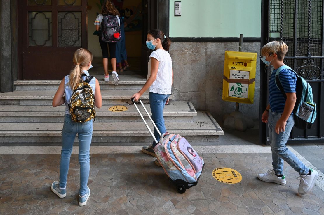 Students wearing masks arrive on September 14 for the start of the school year at the Luigi Einaudi technical high school in Rome, Italy.