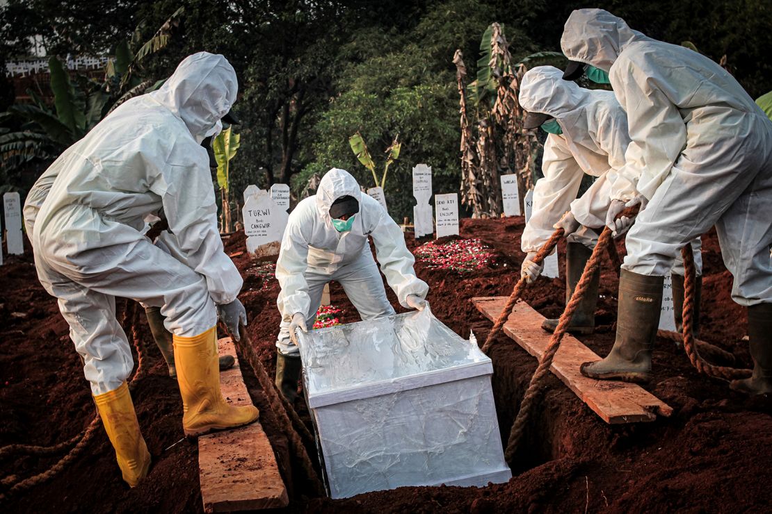 A coffin containing a coronavirus victim is buried in Indonesia's East Jakarta City. 