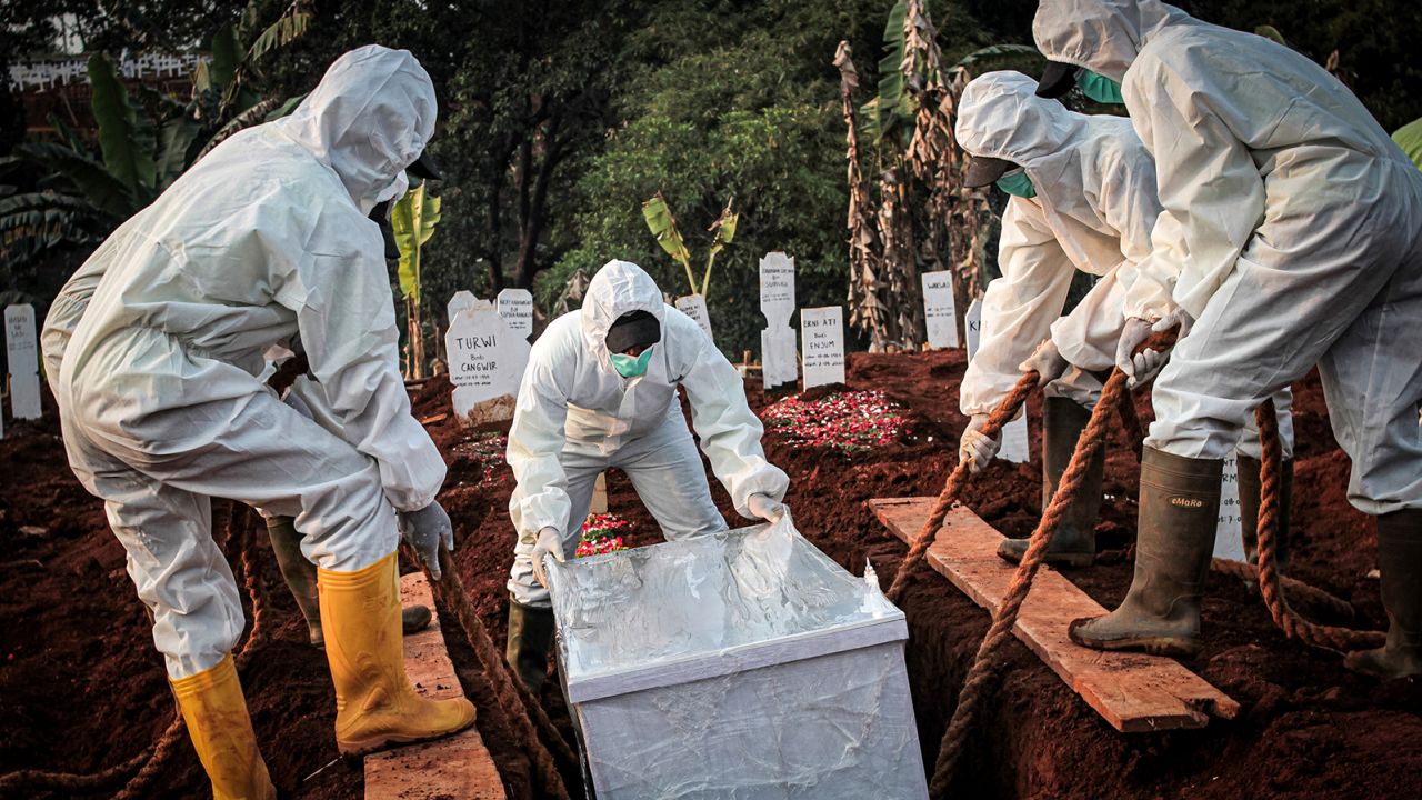 A coffin containing a coronavirus victim is buried in Indonesia's East Jakarta City. 