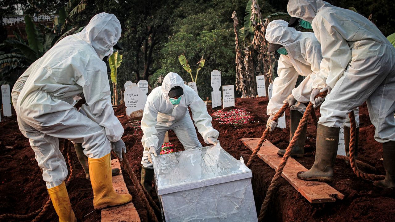 A coffin containing a coronavirus victim is buried in Indonesia's East Jakarta City.