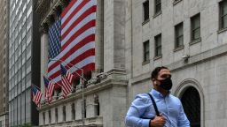 A man wears a face mask as he walk past the New York Stock Exchange building on Wall Street in New York, USA on September 9, 2020.