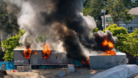 Trailers on a construction site for a youth detention center burn after protesters targeted them during protests in Seattle on July 25. (Editor's note: Part of this photo has been blurred because of profanity.)