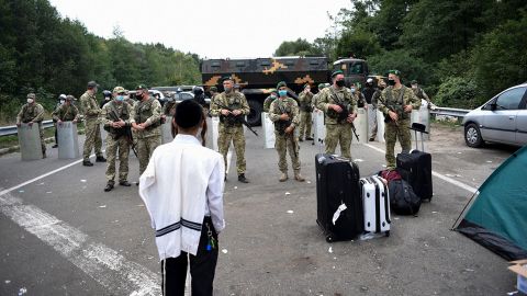 Ukrainian border guards block the road on the Belarus-Ukraine border, as more than 1,000 Jewish pilgrims tried to cross.