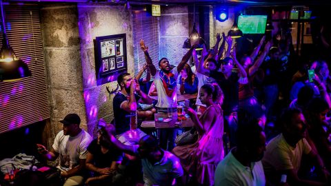 Soccer fans watch a match in Lisbon, Portugal, at a crowded bar on August 12.