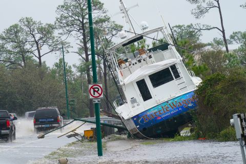 A boat is washed up near a road in Orange Beach, Alabama.