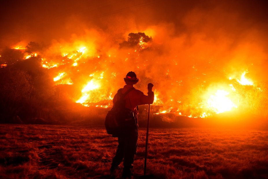 A firefighter works at the scene of the Bobcat Fire burning on hillsides near Monrovia, California, on September 15, 2020.