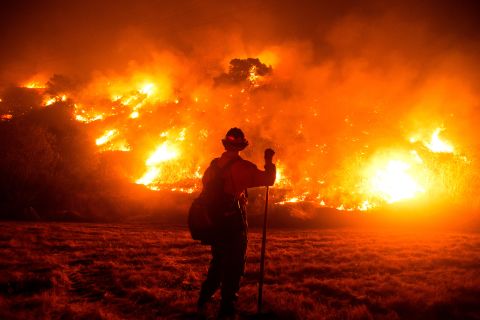 A firefighter works at the scene of the Bobcat Fire burning on hillsides near Monrovia, California, on September 15.
