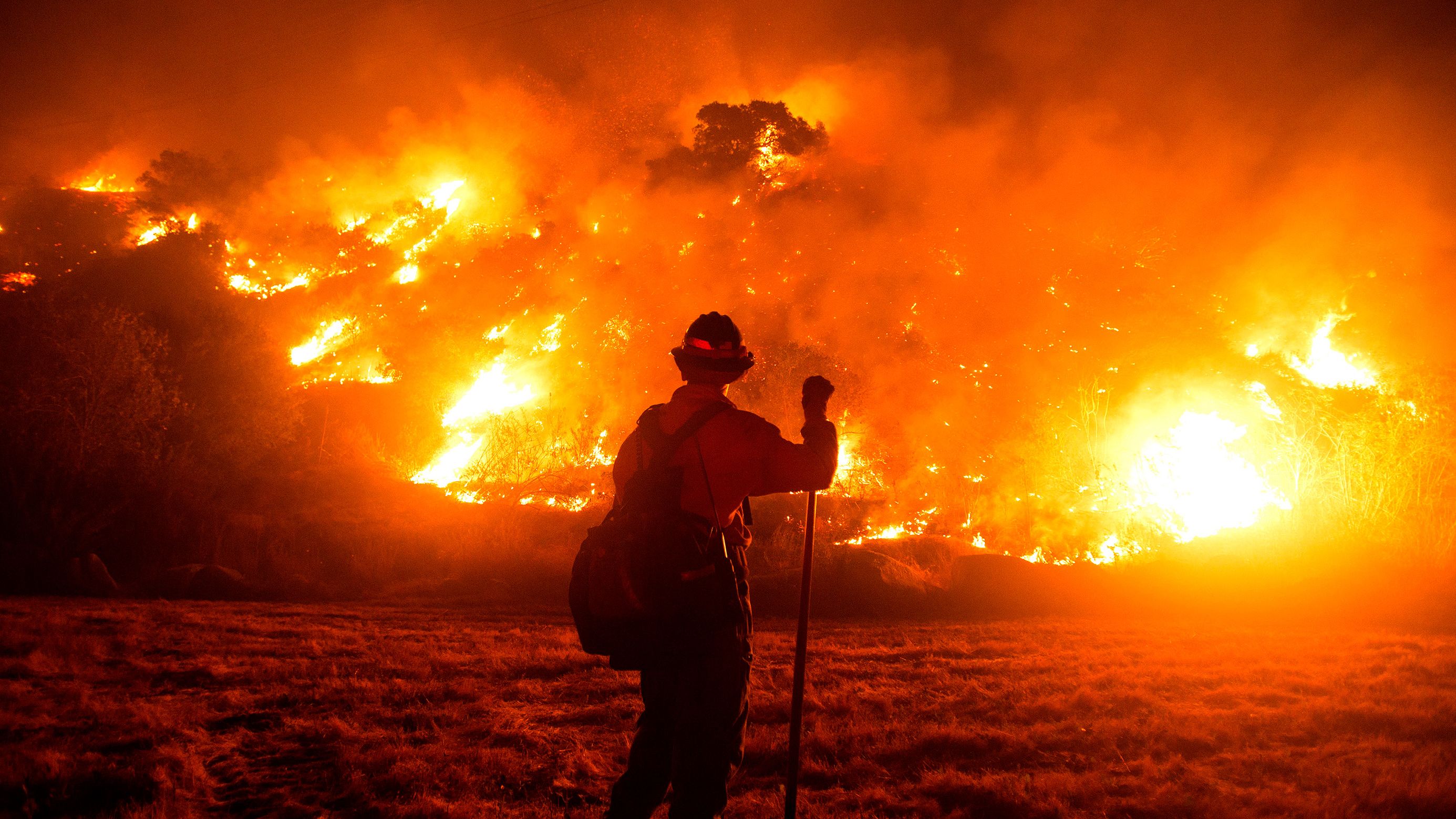 A firefighter works at the scene of the Bobcat Fire burning on hillsides near Monrovia, California, on September 15, 2020.
