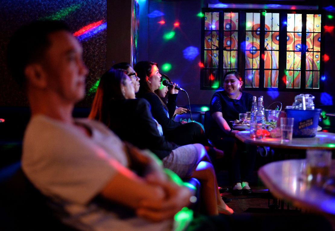 Customers sing karaoke at a nightclub in Davao City, on the southern Philippine island of Mindanao on May 10, 2016.
