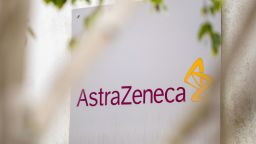 A sign featuring the AstraZeneca Plc logo stands at the company's DaVinci building at the Melbourn Science Park in Cambridge, U.K., on Monday, June 8, 2020. AstraZeneca Plc has made a preliminary approach to rival drugmaker Gilead Sciences Inc. about a potential merger, according to people familiar with the matter, in what would be the biggest health-care deal on record. Photographer: Jason Alden/Bloomberg via Getty Images