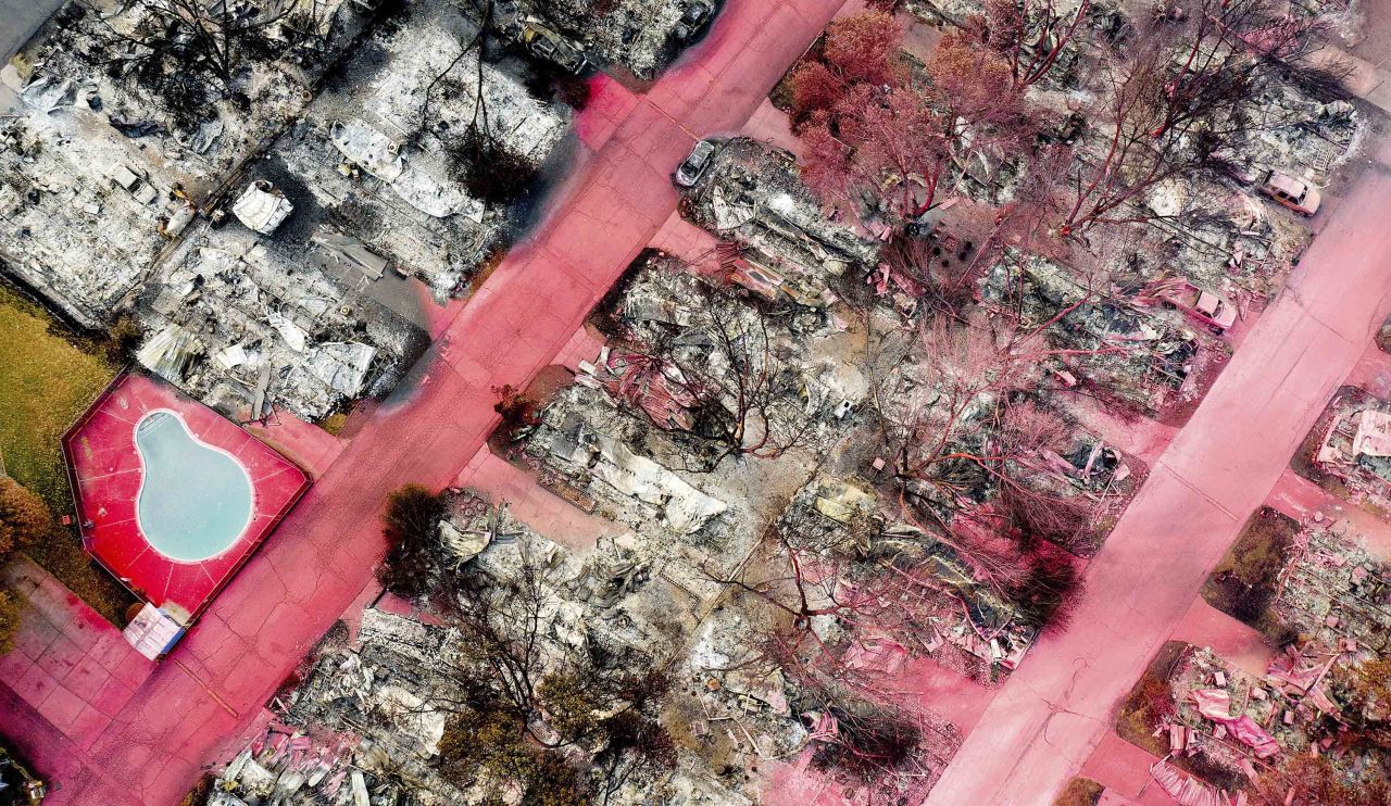 In this aerial photo taken with a drone, red fire retardant sits on leveled homes in Talent, Oregon, on September 15.