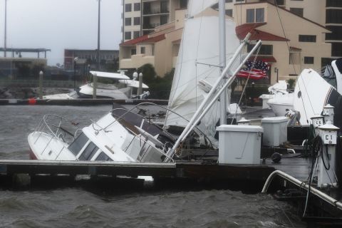 Damaged boats are seen in the Palafox Pier Yacht harbor marina in Pensacola.