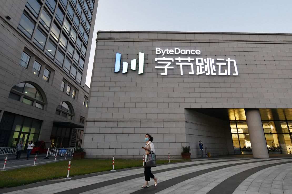 A woman walks past the headquarters of ByteDance, the Chinese parent company of video app TikTok.