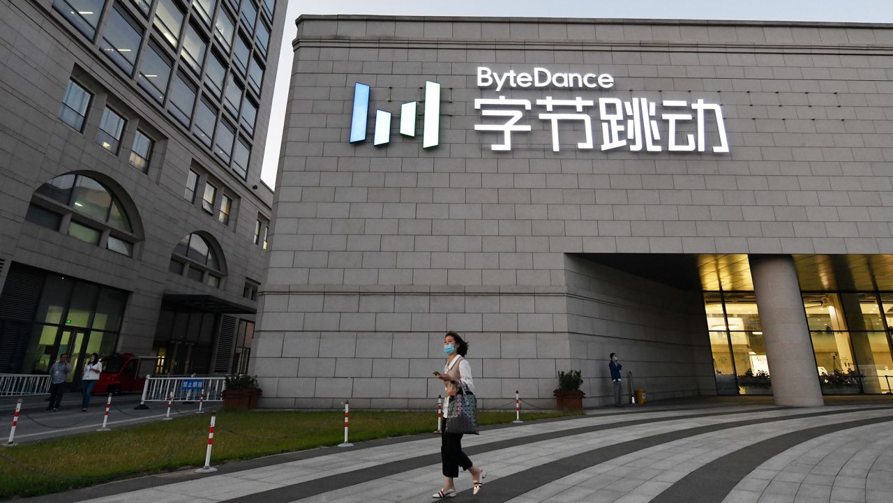 A woman walks past the headquarters of ByteDance, the parent company of video sharing app TikTok, in Beijing on September 16, 2020. - Silicon Valley tech giant Oracle is "very close" to sealing a deal to become the US partner to Chinese-owned video app TikTok to avert a ban in the United States, President Donald Trump said on September 15. (Photo by Greg Baker/AFP/Getty Images)