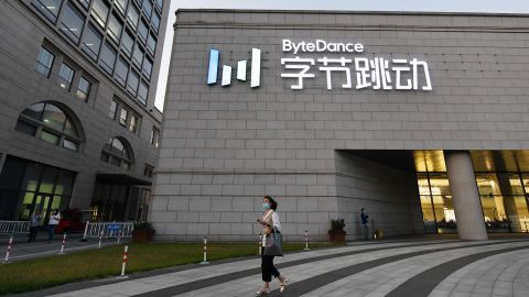 A woman walks past the headquarters of ByteDance, the Chinese parent company of video app TikTok.
