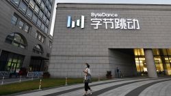 A woman walks past the headquarters of ByteDance, the parent company of video sharing app TikTok, in Beijing on September 16, 2020. - Silicon Valley tech giant Oracle is "very close" to sealing a deal to become the US partner to Chinese-owned video app TikTok to avert a ban in the United States, President Donald Trump said on September 15. (Photo by Greg Baker/AFP/Getty Images)