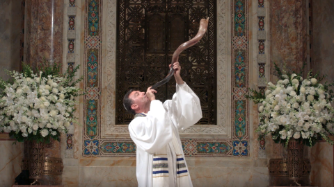 Rabbi Joshua M. Davidson of Temple Emanu-El in New York City blows the shofar.
