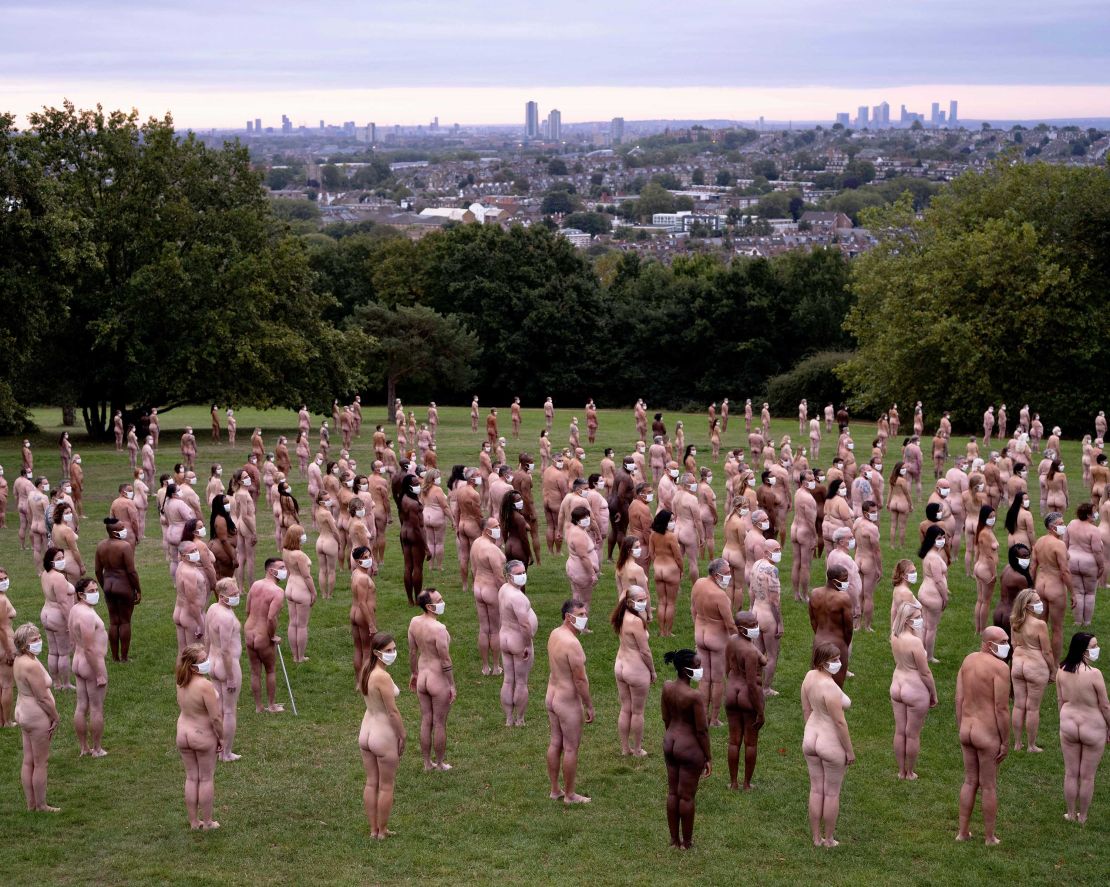 Some 220 people posed nude apart from white face masks at what organizers said was the first major participatory work of art since lockdown.