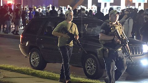 Kyle Rittenhouse, left, with backwards cap, in Kenosha, Wisconsin, on August 25, 2020.  Prosecutors have charged Rittenhouse, 17, in the fatal shooting of two protesters and the wounding of a third in Kenosha during a night of unrest following the police shooting of Jacob Blake. 