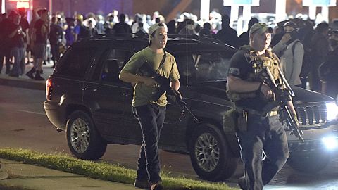 Kyle Rittenhouse, left, with backwards cap, in Kenosha, Wisconsin, on August 25, 2020. Prosecutors have charged Rittenhouse, 17, in the fatal shooting of two protesters and the wounding of a third in Kenosha during a night of unrest following the police shooting of Jacob Blake.