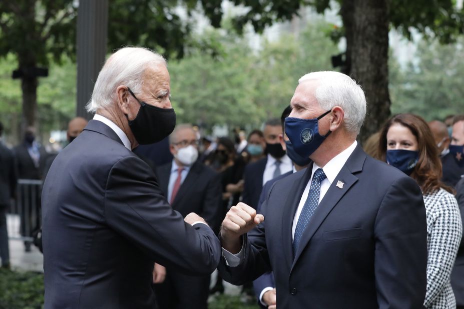 Biden greets Vice President Mike Pence as they attend a ceremony at the 9/11 Memorial in New York City.