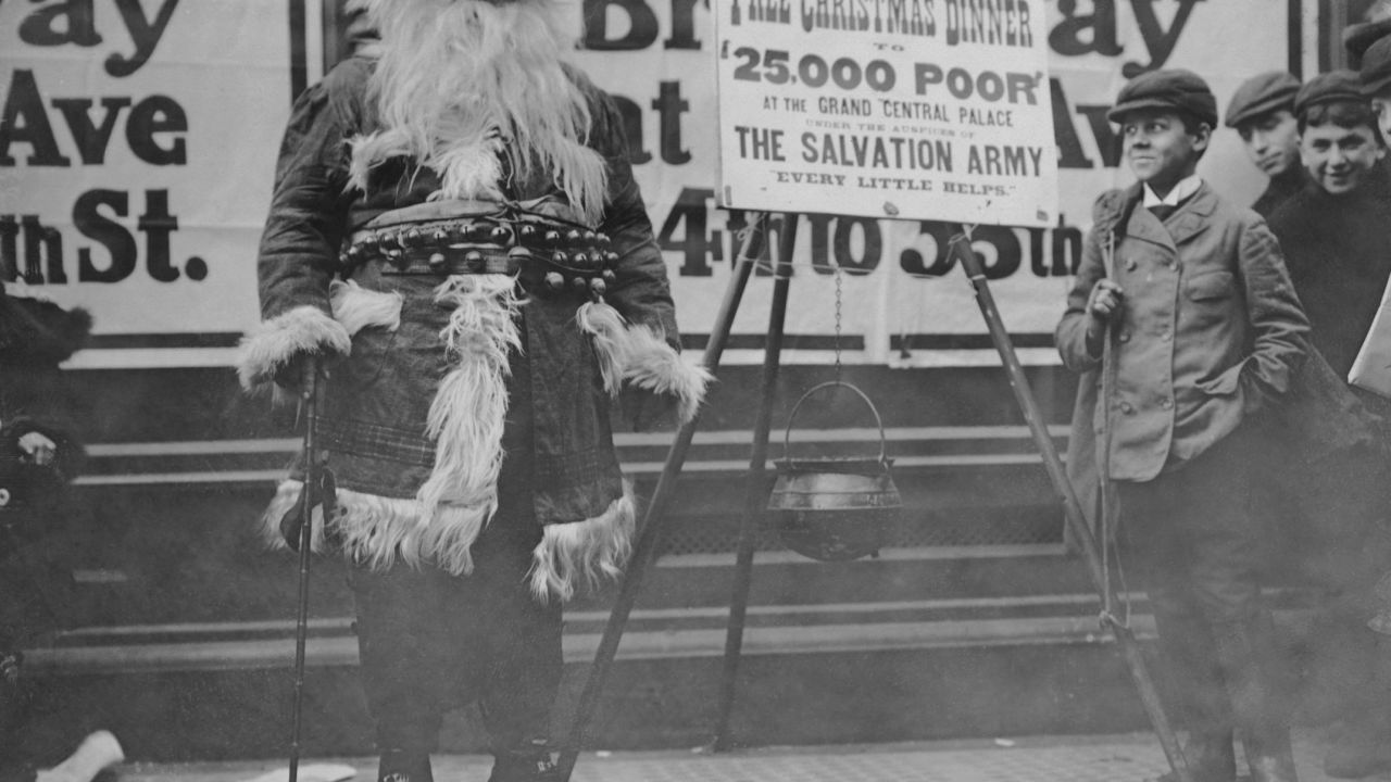 A man in a Santa suit publicizes a free Christmas dinner organized by the Salvation Army in New York, circa 1910. 