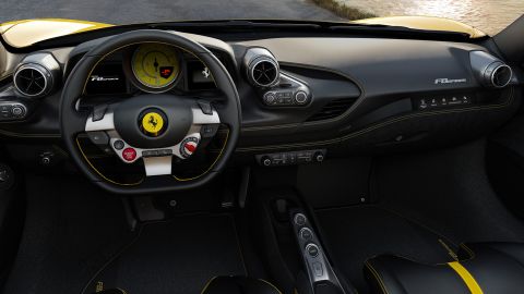 The Ferrari F8's start button is on the steering wheel. For the passenger, there's a narrow touchsreen that can show a speedometer and the engine speed.
